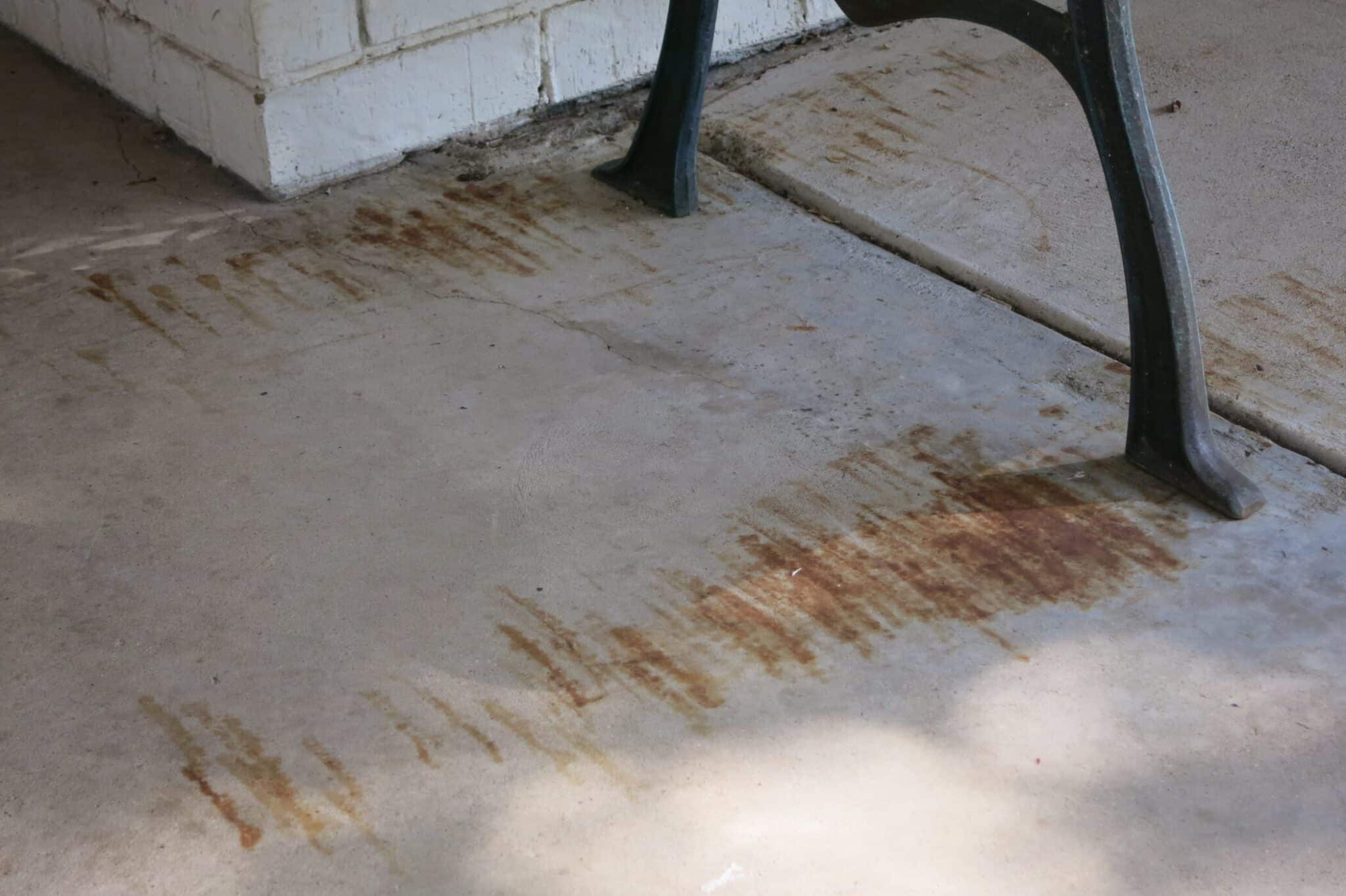 rust stains on concrete porch from metal bench